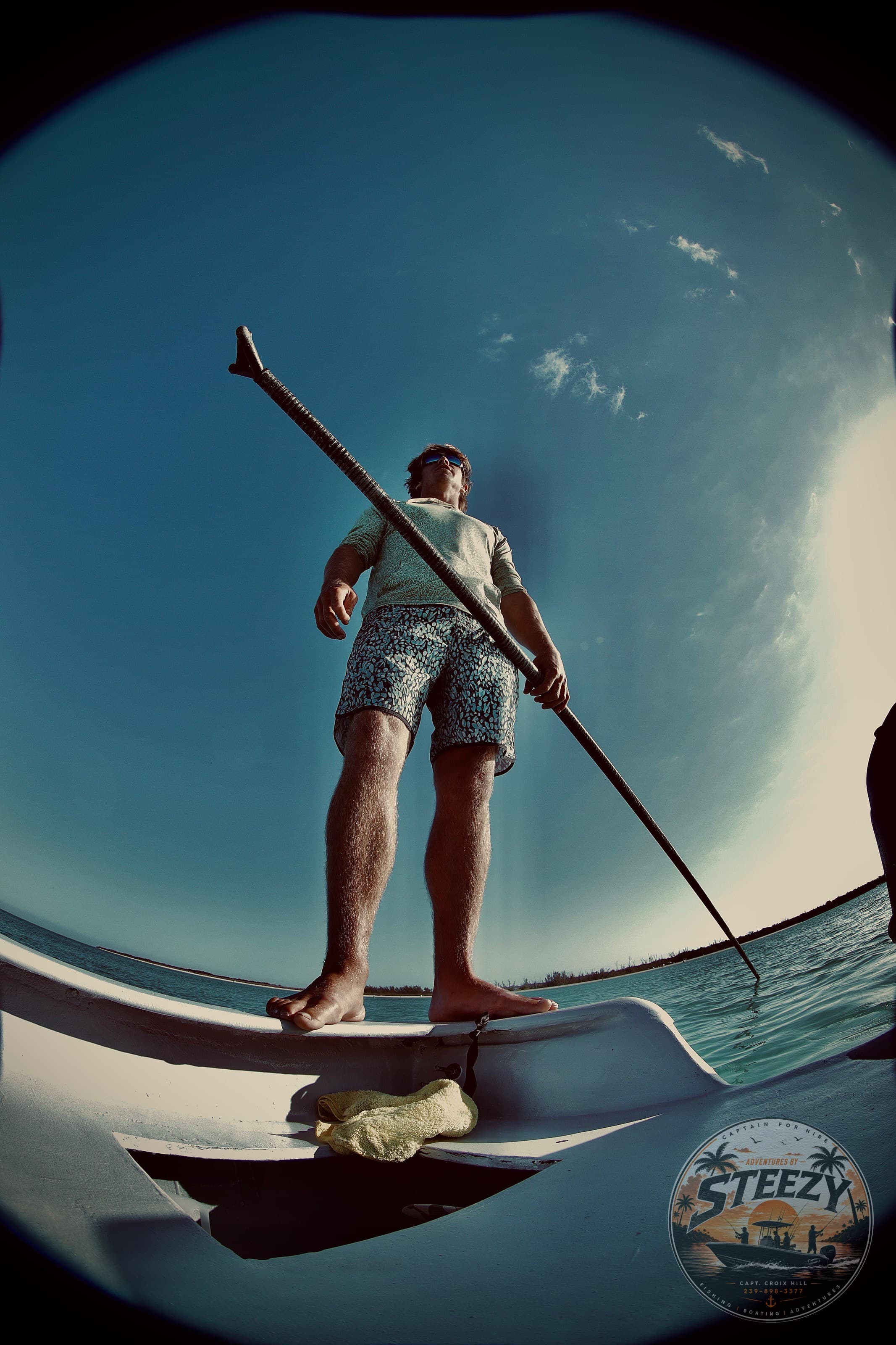 Captain Croix on the bow of the skiff at sunrise